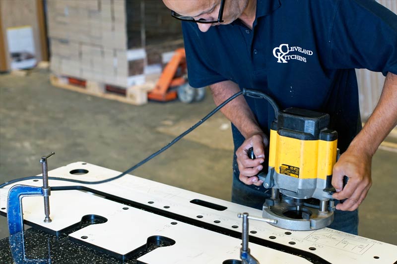 Workshop staff cutting worktops to size prior to delivery in our Liverpool manufacturing factory.