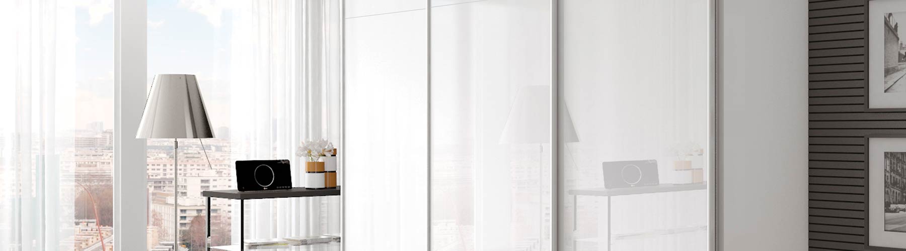 Gloss white sliding wardrobe doors with matt grey handles.