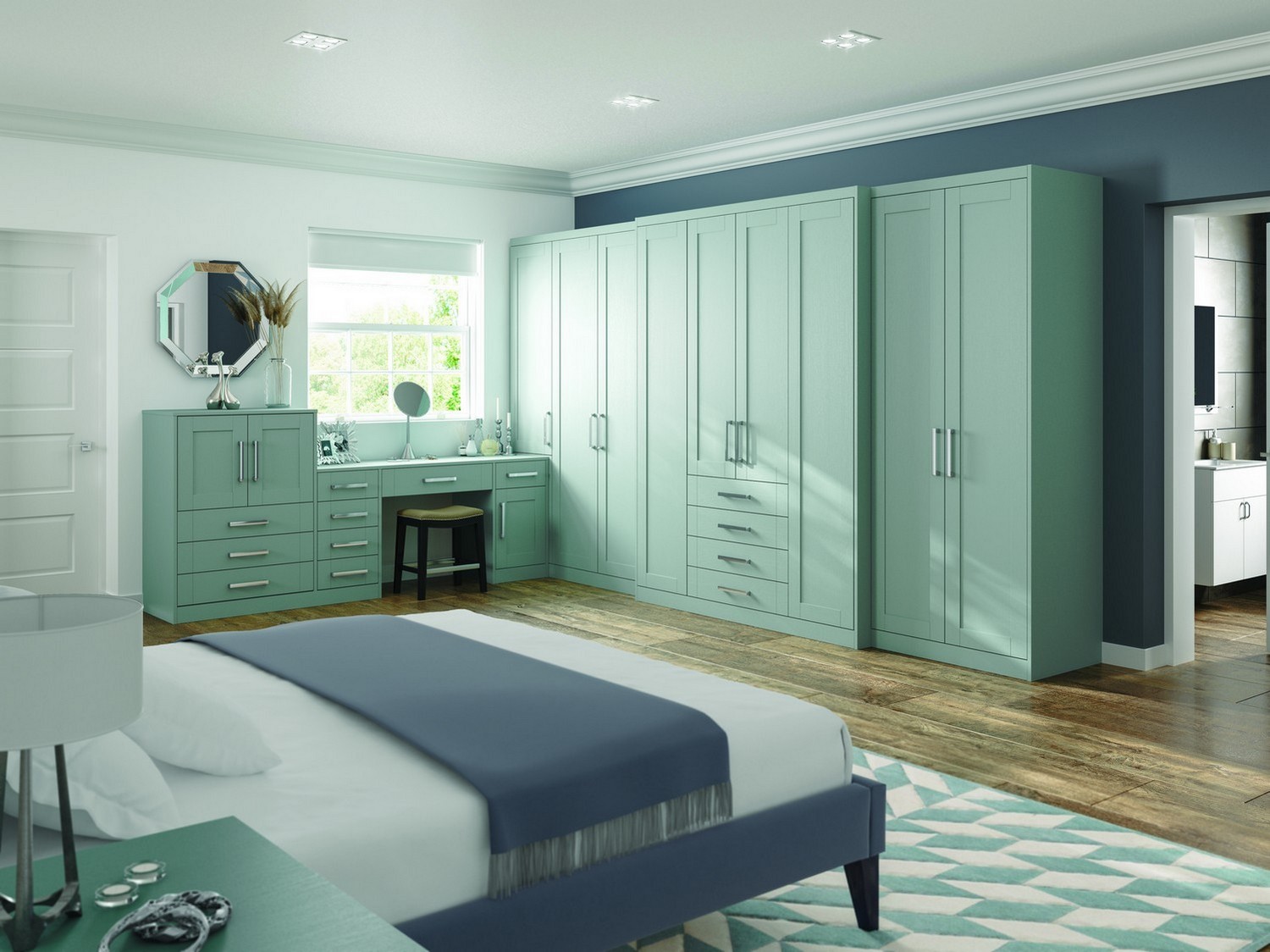 A green shaker bedroom furniture set designed for our client in St Helens featuring a simple chrome handle. This bedroom design feature various wardrobes, dressing table and bedside cabinets.