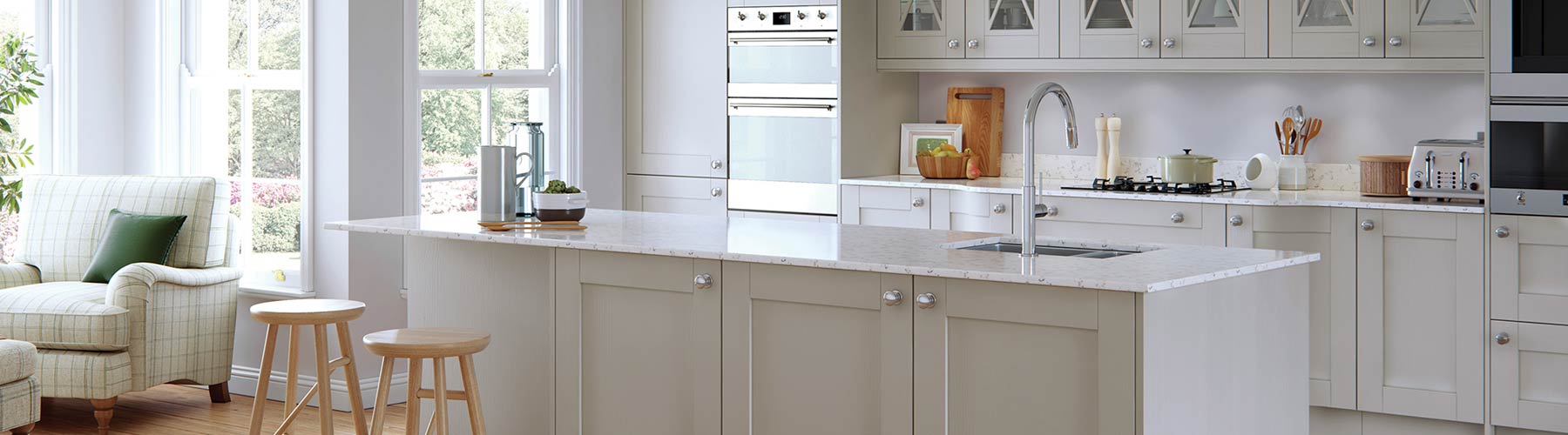 Dust grey shaker kitchen with white Corian marble style worktops.