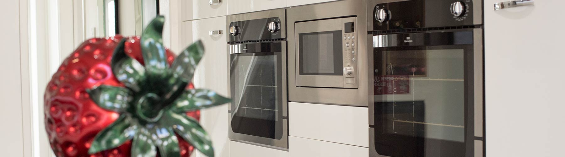 White gloss floor to ceiling larder style cupboards with integrated cooking appliance, Liverpool.