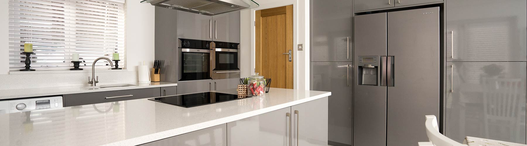 Grey gloss kitchen with white Corian worktops fitted in Kirkby, Liverpool