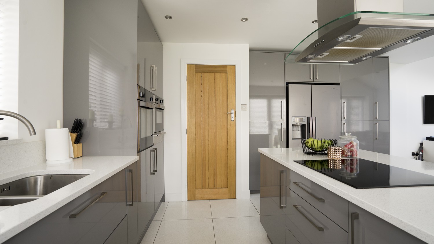Taken from the far end of this space, this kitchen has been installed as part of a larger open plan living space.