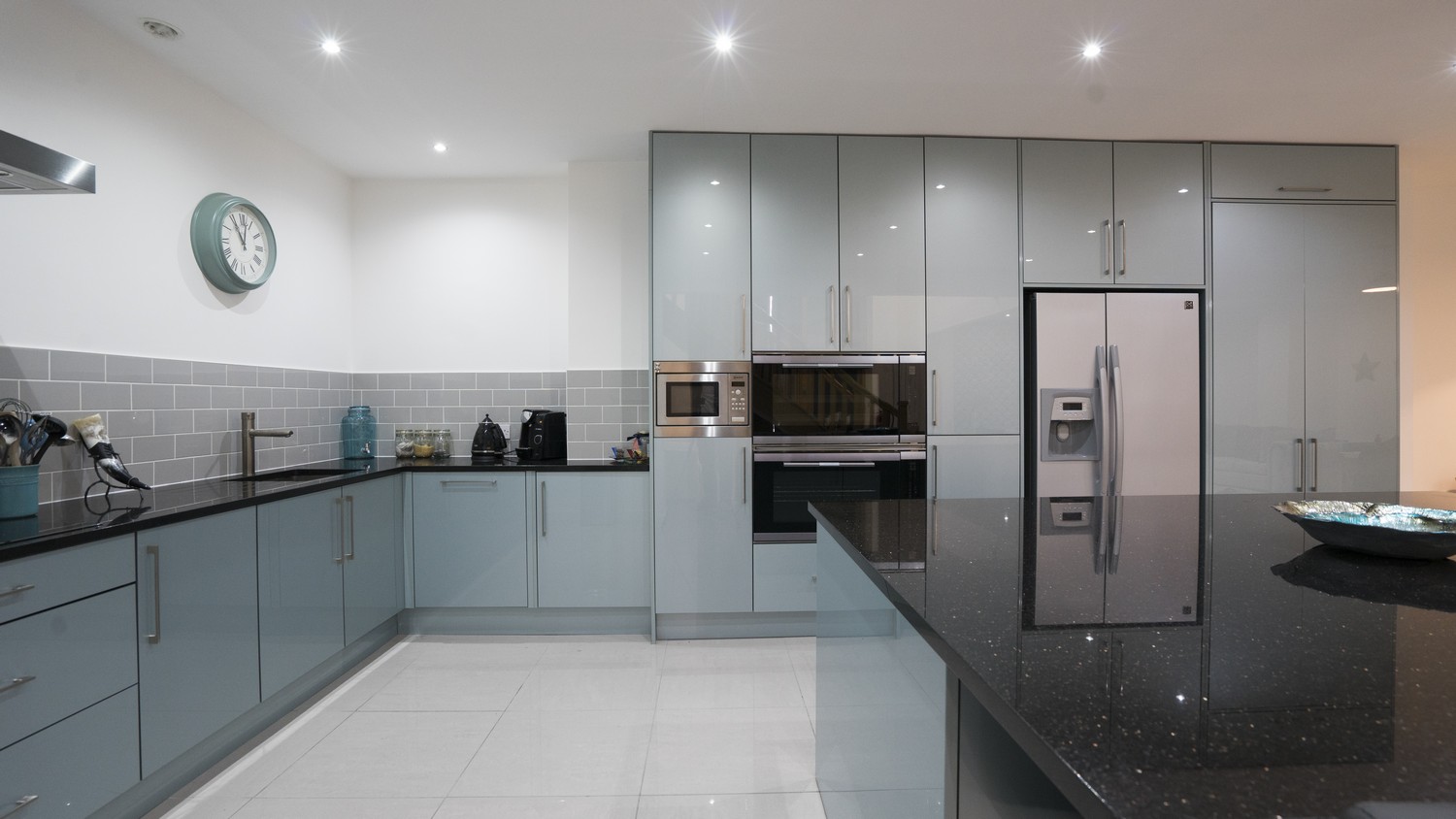 Straight on view of the large central island, lower cupboards and integrated appliances.