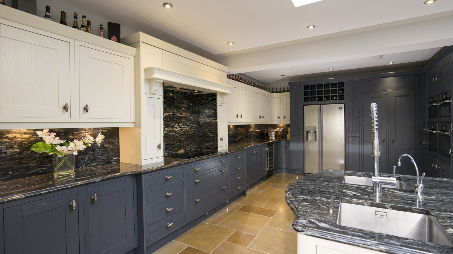 Alternative angle showing the feature wall of cupboards housing the multiple Simens oven and a range of different storage solutions. This kitchen features a various built in appliances Liverpool. 