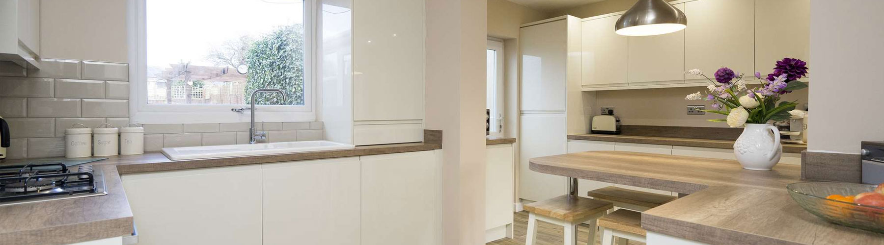 Handleless kitchen with wood effect worktops installed in Warrington.